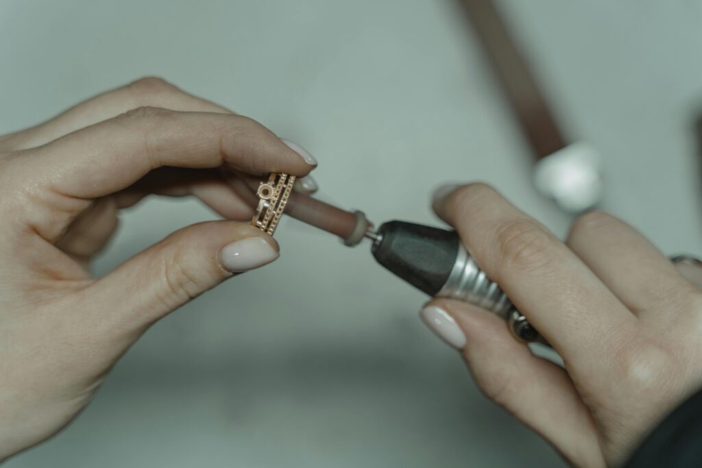 pexels-photo-6263058-6263058 Detailed image of crafting jewelry with precision tools indoors.